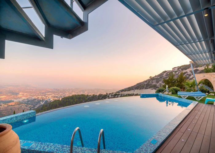 Infinity pool with breathtaking mountain and city views, perfect for a luxury tropical getaway.